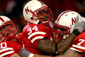 LINCOLN, NE - SEPTEMBER 15:  Cody Glenn #34 of the Nebraska Cornhuskers is congratulated by David Harvey #80 and Matt Slauson #70 after scoring a touchdown against the USC Trojans on September 15, 2007 at Memorial Stadium in Lincoln, Nebraska.  (Photo by Matthew Stockman/Getty Images)