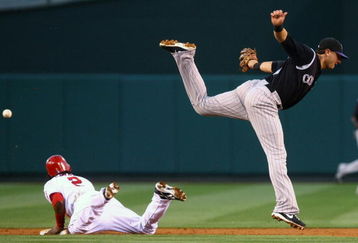ANAHEIM, CA - JUNE 24:  Erick Aybar #2 of the Los Angeles Angels of Anaheim steals second base as the ball gets past shortstop Troy Tulowitzki #2 of the Colorado Rockies during the second inning at Angel Stadium June 24, 2009 in Anaheim, California. The Angels defeated the Rockies 11-3.  (Photo by Jeff Gross/Getty Images)