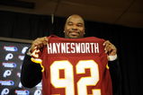 ASHBURN, VA - FEBRUARY 27:  Albert Haynesworth posese with his new jersey at a press conference after signing a 7-year contract worth approximately $100 million with the Washington Redskins on February 27, 2009 at Redskins Park in Ashburn, Virginia.  (Photo by Mitchell Layton/Getty Images)