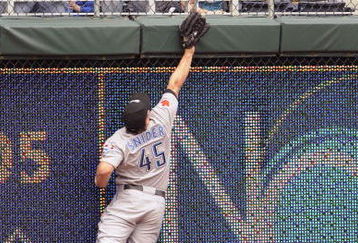 KANSAS CITY, MO - APRIL 30:  Travis Snider #45 of the Toronto Blue Jays leaps up in an attempt to catch a triple hit by John Buck of the Kansas City Royals on April 30, 2009 at Kauffman Stadium in Kansas City, Missouri. (Photo by G. Newman Lowrance/Getty Images)
