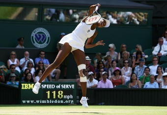 WIMBLEDON, ENGLAND - JUNE 27:  Venus Williams of USA serves during the women's singles third round match against Carla Suarezv Navarro of Spain on Day Six of the Wimbledon Lawn Tennis Championships at the All England Lawn Tennis and Croquet Club on June 27, 2009 in London, England.  (Photo by Paul Gilham/Getty Images)