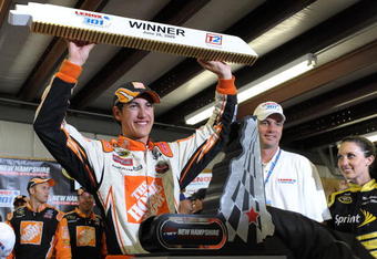 LOUDON, NH - JUNE 28:  Joey Logano, driver of the #20 Home Depot Toyota, celebrates winning the NASCAR Sprint Cup Series LENOX Industrial Tools 301 at New Hampshire Motor Speedway on June 28, 2009 in Loudon, New Hampshire. Logano won the rain shortened race with 27 laps remaining.  (Photo by Drew Hallowell/Getty Images for NASCAR)
