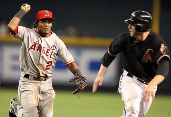PHOENIX - JUNE 27:  Infielder Erick Aybar #2 of the Los Angeles Angels of Anaheim chases Mark Reynolds #27 of the Arizona Diamondbacks during a run down in the major league baseball game at Chase Field on June 27, 2009 in Phoenix, Arizona. The Angels defeated the Diamondbacks 2-1. (Photo by Christian Petersen/Getty Images)