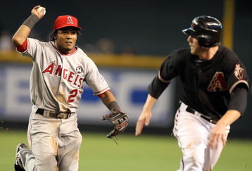 PHOENIX - JUNE 27:  Infielder Erick Aybar #2 of the Los Angeles Angels of Anaheim chases Mark Reynolds #27 of the Arizona Diamondbacks during a run down in the major league baseball game at Chase Field on June 27, 2009 in Phoenix, Arizona. The Angels defeated the Diamondbacks 2-1. (Photo by Christian Petersen/Getty Images)