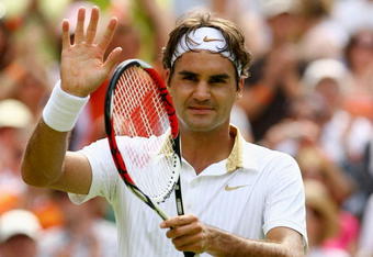 WIMBLEDON, ENGLAND - JUNE 26:  Roger Federer of Switzerland salutes the crowd after victory during the men's singles third round match against Philipp Kohlschreiber of Germany on Day Five of the Wimbledon Lawn Tennis Championships at the All England Lawn Tennis and Croquet Club on June 26, 2009 in London, England.  (Photo by Paul Gilham/Getty Images)