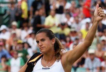 WIMBLEDON, ENGLAND - JUNE 27:  Amelie Mauresmo of France salutes the crowd after victory during the women's singles third round match against Flavia Pennetta of Italy on Day Six of the Wimbledon Lawn Tennis Championships at the All England Lawn Tennis and Croquet Club on June 27, 2009 in London, England.  (Photo by Ian Walton/Getty Images)