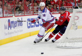 WASHINGTON - APRIL 28:   Tomas Fleischmann #14  of the Washington Capitals battles for a loose puck behind the net with Marc Staal #18 of the New York Rangers during Game Seven of the Eastern Conference Quarterfinal Round of the 2009 Stanley Cup Playoffs on April 28, 2009 at the Verizon Center in Washington,  DC.  (Photo by Len Redkoles/Getty Images)