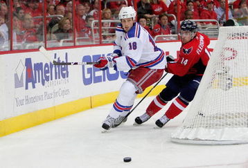 WASHINGTON - APRIL 28:   Tomas Fleischmann #14  of the Washington Capitals battles for a loose puck behind the net with Marc Staal #18 of the New York Rangers during Game Seven of the Eastern Conference Quarterfinal Round of the 2009 Stanley Cup Playoffs on April 28, 2009 at the Verizon Center in Washington,  DC.  (Photo by Len Redkoles/Getty Images)
