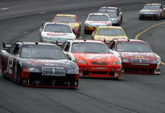 LOUDON, NH - JUNE 28:  David Stremme, driver of the #12 Penske Dodge, races Joey Logano, driver of the #20 Home Depot Toyota, and Reed Sorenson, driver of the #43 McDonald's McCafe Dodge, during the NASCAR Sprint Cup Series LENOX Industrial Tools 301 at New Hampshire Motor Speedway on June 28, 2009 in Loudon, New Hampshire.  (Photo by Chris Trotman/Getty Images)