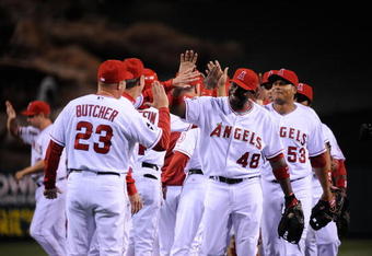 ANAHEIM, CA - APRIL 10: Torii Hunter #48 of the Los Angeles Angels high fives pitching coach Mike Butcher #23 after defeating the Boston Red Sox on April 10, 2009 at Angel Stadium in Anaheim, California. The Angels won 6-3.  (Photo by Kevork Djansezian/Getty Images)