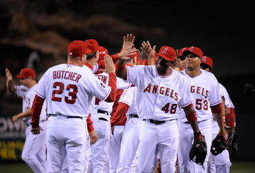 ANAHEIM, CA - APRIL 10: Torii Hunter #48 of the Los Angeles Angels high fives pitching coach Mike Butcher #23 after defeating the Boston Red Sox on April 10, 2009 at Angel Stadium in Anaheim, California. The Angels won 6-3.  (Photo by Kevork Djansezian/Getty Images)