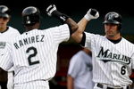 MIAMI - JULY 17:  Dan Uggla #6 of the Florida Marlins congratulates Hanley Ramirez #2 after Ramirez hit a solo home run in the first inning against the Washington Nationals at Dolphin Stadium on July 17, 2006 in Miami, Florida.  (Photo by Doug Benc/Getty Images)