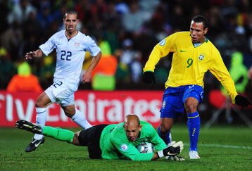 JOHANNESBURG, SOUTH AFRICA - JUNE 28:  Tim Howard of USA dives to make a save at the feet of Luis Fabiano of Brazil during the FIFA Confederations Cup Final between USA and Brazil at the Ellis Park Stadium on June 28, 2009 in Johannesburg, South Africa.  (Photo by Laurence Griffiths/Getty Images)