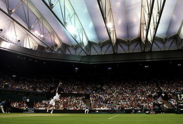 WIMBLEDON, ENGLAND - JUNE 29:  Andy Murray of Great Britain serves under the new Centre Court roof during the men's singles fourth round match against Stanislas Wawrinka of Switzerland on Day Seven of the Wimbledon Lawn Tennis Championships at the All England Lawn Tennis and Croquet Club on June 29, 2009 in London, England.  (Photo by Julian Finney/Getty Images)