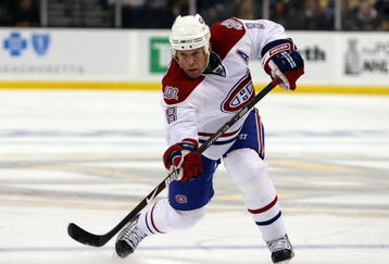 BOSTON - APRIL 16:  Mike Komisarek #8 of the Montreal Canadiens passes the puck against the Boston Bruins during Game 1 of the Eastern Conference quarterfinals of the 2009 Stanley Cup playoffs on April 16, 2009 at the TD Banknorth Garden in Boston, Massachusetts.  (Photo by Elsa/Getty Images)