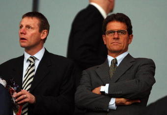 LONDON, ENGLAND - APRIL 15:  England Manager Fabio Capello (R) and England coach Stuart Pearce  look on prior to the UEFA Champions League Quarter Final Second Leg match between Arsenal and Villarreal at the Emirates Stadium on April 15, 2009 in London, England.  (Photo by Hamish Blair/Getty Images)