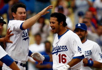 LOS ANGELES, CA - JUNE 06:  Andre Ethier #16 of the Los Angeles Dodgers is congratulated by Mark Loretta #5 and the rest of his teammates after hitting a walk-off homerun to win the game in the 12th inning against the Philadelphia Phillies at Dodger Stadium on June 6, 2009 in Los Angeles, California. The Dodgers defeated the Phillies 3-2 in twelve innings.  (Photo by Jeff Gross/Getty Images)