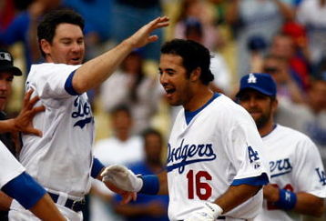 LOS ANGELES, CA - JUNE 06:  Andre Ethier #16 of the Los Angeles Dodgers is congratulated by Mark Loretta #5 and the rest of his teammates after hitting a walk-off homerun to win the game in the 12th inning against the Philadelphia Phillies at Dodger Stadium on June 6, 2009 in Los Angeles, California. The Dodgers defeated the Phillies 3-2 in twelve innings.  (Photo by Jeff Gross/Getty Images)
