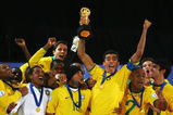 JOHANNESBURG, SOUTH AFRICA - JUNE 28:  Lucio of Brazil lifts the trophy as his team mates celebrate following their victory at the end of the FIFA Confederations Cup Final between USA and Brazil at the Ellis Park Stadium on June 28, 2009 in Johannesburg, South Africa.  (Photo by Alex Livesey/Getty Images)