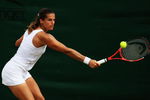 WIMBLEDON, ENGLAND - JUNE 27:  Amelie Mauresmo of France plays a backhand during the women's singles third round match against Flavia Pennetta of Italy on Day Six of the Wimbledon Lawn Tennis Championships at the All England Lawn Tennis and Croquet Club on June 27, 2009 in London, England.  (Photo by Ian Walton/Getty Images)