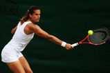 WIMBLEDON, ENGLAND - JUNE 27:  Amelie Mauresmo of France plays a backhand during the women's singles third round match against Flavia Pennetta of Italy on Day Six of the Wimbledon Lawn Tennis Championships at the All England Lawn Tennis and Croquet Club on June 27, 2009 in London, England.  (Photo by Ian Walton/Getty Images)
