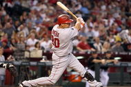 PHOENIX - JUNE 27:  Juan Rivera #20 of the Los Angeles Angels of Anaheim hits a single against the Arizona Diamondbacks during the major league baseball game at Chase Field on June 27, 2009 in Phoenix, Arizona. The Angels defeated the Diamondbacks 2-1.  (Photo by Christian Petersen/Getty Images)