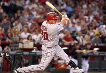 PHOENIX - JUNE 27:  Juan Rivera #20 of the Los Angeles Angels of Anaheim hits a single against the Arizona Diamondbacks during the major league baseball game at Chase Field on June 27, 2009 in Phoenix, Arizona. The Angels defeated the Diamondbacks 2-1.  (Photo by Christian Petersen/Getty Images)