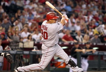 PHOENIX - JUNE 27:  Juan Rivera #20 of the Los Angeles Angels of Anaheim hits a single against the Arizona Diamondbacks during the major league baseball game at Chase Field on June 27, 2009 in Phoenix, Arizona. The Angels defeated the Diamondbacks 2-1.  (Photo by Christian Petersen/Getty Images)