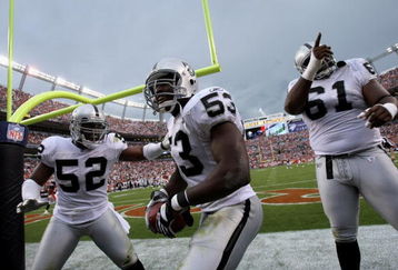 DENVER - SEPTEMBER 16:  Thomas Howard #53 of the Oakland Raiders celebrates his interception for a touchdown with Kirk Morrison #52 and Gerard Warren #61 against the Denver Broncos as the Broncos defeated the Raiders 23-20 in overtime during week two NFL action at Invesco Field at Mile High on September 16, 2007 in Denver, Colorado.  (Photo by Doug Pensinger/Getty Images)