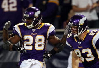 MINNEAPOLIS - JANUARY 4:  Adrian Peterson #28 of the Minnesota Vikings celebrates his touchdown with teammate Jeff Dugan #83 in the first half against the Philadelphia Eagles during the NFC Wild Card playoff game on January 4, 2009 at the Hubert H. Humphrey Metrodome in Minneapolis, Minnesota. (Photo by Elsa/Getty Images)