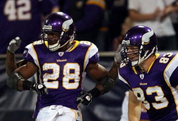 MINNEAPOLIS - JANUARY 4:  Adrian Peterson #28 of the Minnesota Vikings celebrates his touchdown with teammate Jeff Dugan #83 in the first half against the Philadelphia Eagles during the NFC Wild Card playoff game on January 4, 2009 at the Hubert H. Humphrey Metrodome in Minneapolis, Minnesota. (Photo by Elsa/Getty Images)