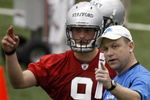 ALLEN PARK, MI - MAY 01:  Offensive coordinator Scott Linehan of the Detroit Lions talks with Matthew Stafford #9 during rookie orientation camp at the Detroit Lions Headquarters and Training Facility on May 1, 2009 in Allen Park, Michigan.  (Photo by Gregory Shamus/Getty Images)