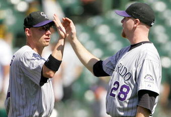 OAKLAND, CA - JUNE 28:  Aaron Cook #28 of the Colorado Rockies is congratulated by Clint Barmes #12 after they beat the Oakland Athletics at the Oakland Coliseum on June 28, 2009 in Oakland, California.  (Photo by Ezra Shaw/Getty Images)