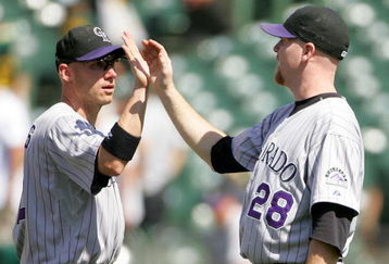 OAKLAND, CA - JUNE 28:  Aaron Cook #28 of the Colorado Rockies is congratulated by Clint Barmes #12 after they beat the Oakland Athletics at the Oakland Coliseum on June 28, 2009 in Oakland, California.  (Photo by Ezra Shaw/Getty Images)