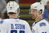 DETROIT - JANUARY 17:  The Sedin brothers Daniel #22 and Henrik #33 of the Vancouver Canucks chat prior to a faceoff in a game against the Detroit Red Wings on January 17, 2008 at the Joe Louis Arena in Detroit, Michigan. The Wings defeated the Canucks 3-2 in a shootout. (Photo by Claus Andersen/Getty Images)