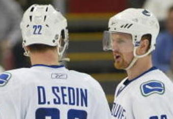 DETROIT - JANUARY 17:  The Sedin brothers Daniel #22 and Henrik #33 of the Vancouver Canucks chat prior to a faceoff in a game against the Detroit Red Wings on January 17, 2008 at the Joe Louis Arena in Detroit, Michigan. The Wings defeated the Canucks 3-2 in a shootout. (Photo by Claus Andersen/Getty Images)