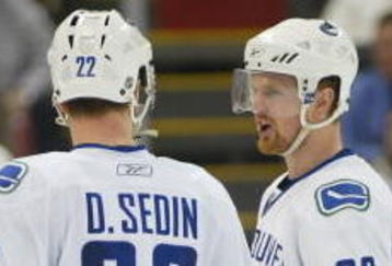 DETROIT - JANUARY 17:  The Sedin brothers Daniel #22 and Henrik #33 of the Vancouver Canucks chat prior to a faceoff in a game against the Detroit Red Wings on January 17, 2008 at the Joe Louis Arena in Detroit, Michigan. The Wings defeated the Canucks 3-2 in a shootout. (Photo by Claus Andersen/Getty Images)