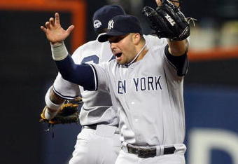 NEW YORK - JUNE 27:  Nick Swisher #33 and Robinson Cano #24 of the New York Yankees celebrate after defeating the New York Mets on June 27, 2009 at Citi Field in the Flushing neighborhood of the Queens borough of New York City.  (Photo by Jim McIsaac/Getty Images)