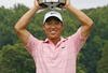 BETHESDA, MD - JULY 6: Anthony Kim holds the championship trophy after winning the AT&T National at Congressional Country Club on July 6, 2008 in Bethesda, Maryland. (Photo by Hunter Martin/Getty Images)