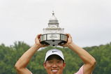 BETHESDA, MD - JULY 6: Anthony Kim holds the championship trophy after winning the AT&T National at Congressional Country Club on July 6, 2008 in Bethesda, Maryland. (Photo by Hunter Martin/Getty Images)