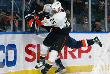 UNIONDALE, NY - JANUARY 21:  Chris Pronger #25 of the Anaheim Ducks throws a hit against Blake Comeau #57 of the New York Islanders on January 21, 2009 at Nassau Coliseum in Uniondale, New York.  (Photo by Jim McIsaac/Getty Images)