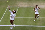WIMBLEDON, ENGLAND - JUNE 29:  Serena Williams Venus Williams of USA (L) plays a smash playing Venus Williams with  of USA during the women's doubles third round match against Zi Yan of China and Jie Zheng of China on Day Seven of the Wimbledon Lawn Tennis Championships at the All England Lawn Tennis and Croquet Club on June 29, 2009 in London, England.  (Photo by Hamish Blair/Getty Images)