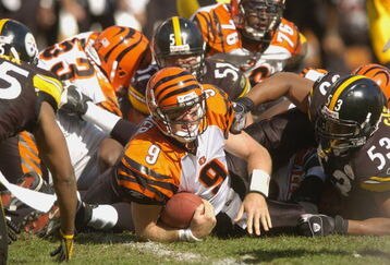 PITTSBURGH, PA - SEPTEMBER 24:  Carson Palmer #9 of the Cincinnati Bengals is tackled during the NFL game against the Pittsburgh Steelers on September 24, 2006 at Heinz Field in Pittsburgh, Pennsylvania. The Bengals won the game 28-20.  (Photo by Greg Fiume/Getty Images) 