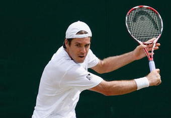 WIMBLEDON, ENGLAND - JUNE 29:  Tommy Haas of Germany plays a backhand during the men's singles third round match against Igor Andreev of Russia on Day Seven of the Wimbledon Lawn Tennis Championships at the All England Lawn Tennis and Croquet Club on June 29, 2009 in London, England.  (Photo by Paul Gilham/Getty Images)