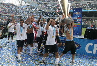 CHICAGO - JUNE 24:  Carlos Bocanegra (2nd R) #3 and Frankie Hejduk (no shirt holding trophy) #2 of the USA celebrate with the trophy after their 2-1 win against Mexico during the CONCACAF Gold Cup Final match at Soldier Field on June 24, 2007 in Chicago, Illinois.  (Photo by Jonathan Daniel/Getty Images)