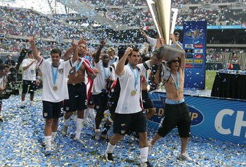 CHICAGO - JUNE 24:  Carlos Bocanegra (2nd R) #3 and Frankie Hejduk (no shirt holding trophy) #2 of the USA celebrate with the trophy after their 2-1 win against Mexico during the CONCACAF Gold Cup Final match at Soldier Field on June 24, 2007 in Chicago, Illinois.  (Photo by Jonathan Daniel/Getty Images)