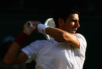 WIMBLEDON, ENGLAND - JUNE 26:  Novak Djokovic of Serbia plays a backhand during the men's singles third round match against Mardy Fish of USA on Day Five of the Wimbledon Lawn Tennis Championships at the All England Lawn Tennis and Croquet Club on June 26, 2009 in London, England.  (Photo by Paul Gilham/Getty Images)