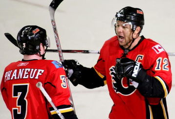 CALGARY, AB - APRIL 22: Jarome Iginla #12 and Dion Phaneuf #3 of the Calgary Flames celebrate Iginla's empty net goal to seal the win against the Chicago Blackhawks in Game Four of the Western Conference Quarterfinals of the 2009 Stanley Cup Playoffs on April 22, 2009 at the Pengrowth Saddledome in Calgary, Alberta, Canada. (Photo by Mike Ridewood/Getty Images)