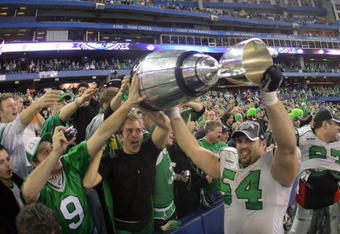 TORONTO - NOVEMBER 25:  Jeremy O'Day #54 of the Saskatchewan Rough Riders hoists the Grey Cup with fans in celebration of a 23-19 victory over the Winnipeg Blue Bombers during the 95th Grey Cup on November 25, 2007 at the Rogers Centre in Toronto, Ontario, Canada.  (Photo by Harry How/Getty Images)