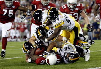 TAMPA, FL - FEBRUARY 01:   Aaron Smith #91, James Farrior #51, Brett Keisel #99, Lawrence Timmons #94 and LaMarr Woodley #56 of the Pittsburgh Steelers tackle Wide receiver Anquan Boldin #81 of the Arizona Cardinals before the goalline on a 45-yard reception by Boldin during the second quarter of Super Bowl XLIII on February 1, 2009 at Raymond James Stadium in Tampa, Florida.  (Photo by Streeter Lecka/Getty Images)